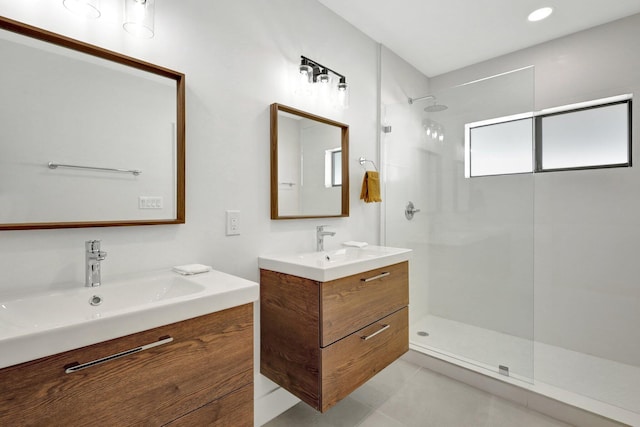 bathroom with vanity, tile patterned floors, and a tile shower