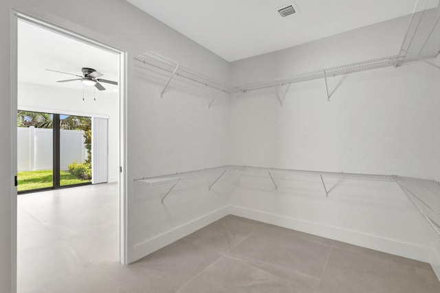 spacious closet featuring ceiling fan and light tile patterned flooring