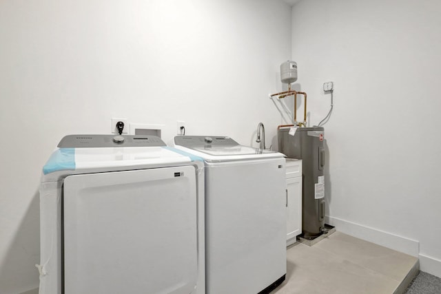 laundry area featuring cabinets, washing machine and clothes dryer, and electric water heater