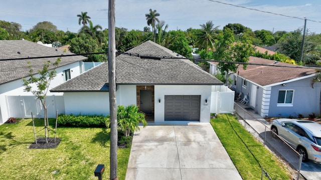 single story home with a front yard and a garage