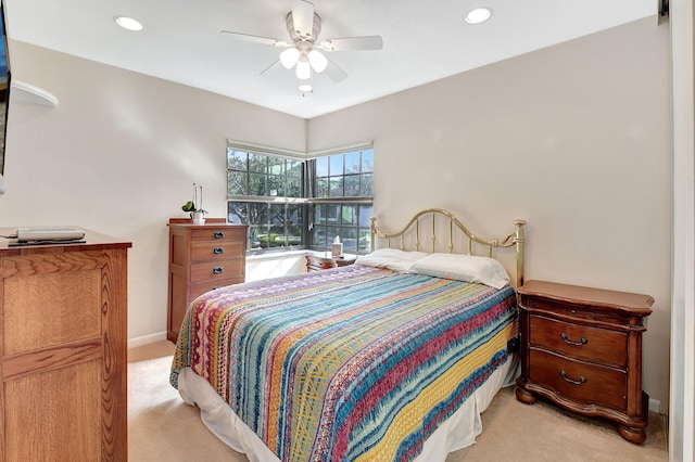 bedroom featuring light colored carpet and ceiling fan