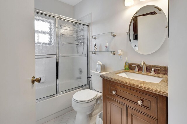 full bathroom featuring vanity, bath / shower combo with glass door, and toilet