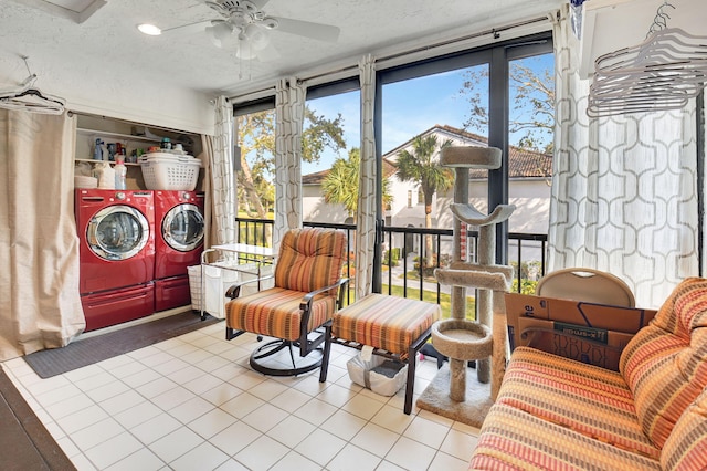 sunroom with ceiling fan and independent washer and dryer