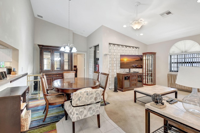 tiled dining area featuring lofted ceiling and an inviting chandelier