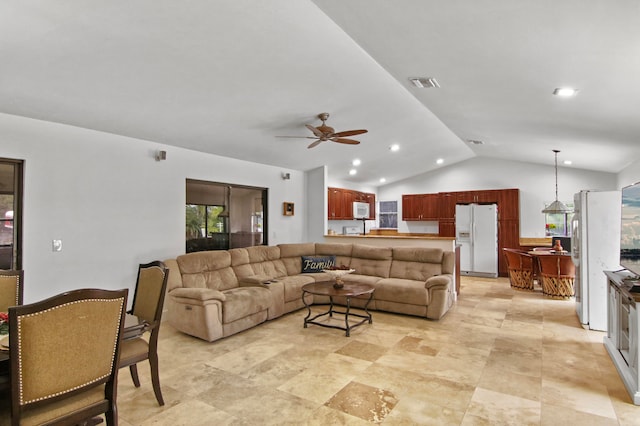 living room featuring ceiling fan and lofted ceiling