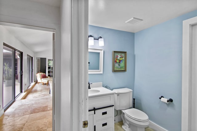 bathroom featuring vanity and toilet