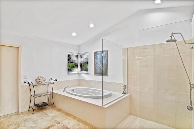 bathroom featuring vaulted ceiling and shower with separate bathtub