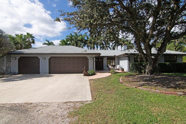 ranch-style home featuring a front yard and a garage