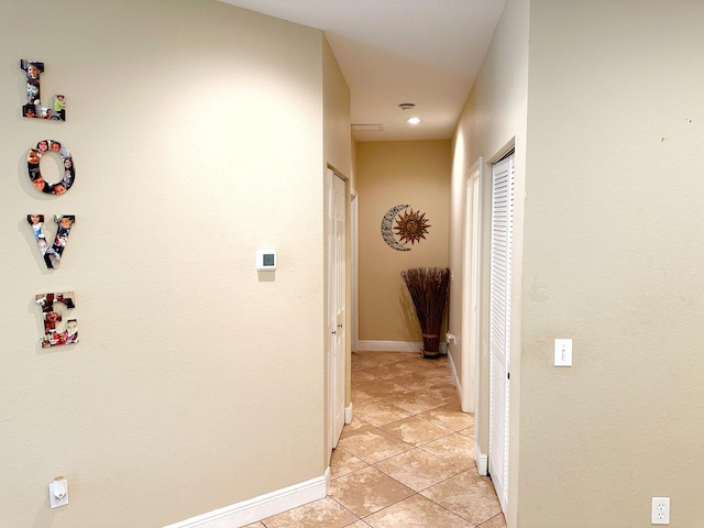 hall featuring light tile patterned flooring