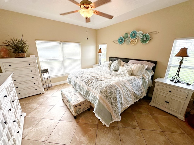 bedroom with ceiling fan and light tile patterned floors