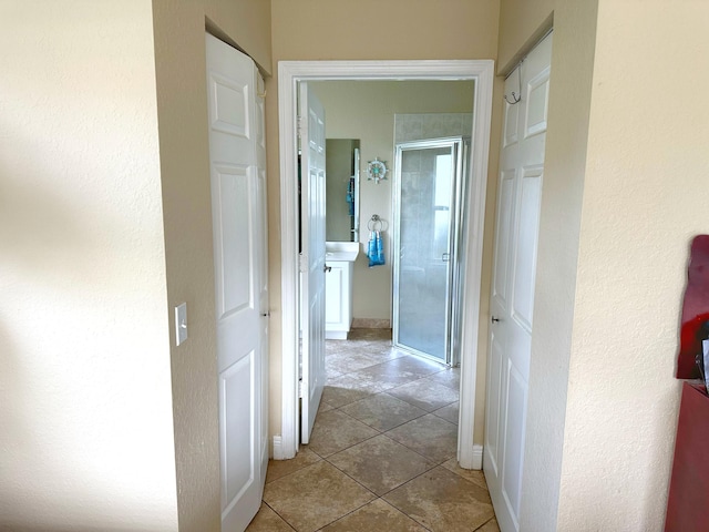 corridor featuring light tile patterned floors