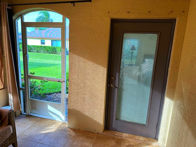 doorway featuring light tile patterned floors