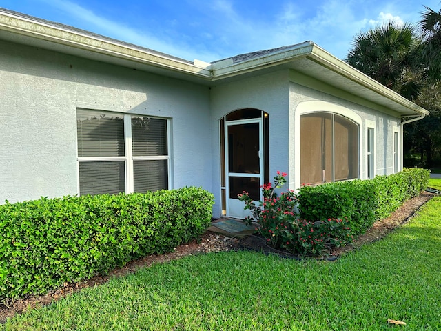 doorway to property featuring a yard