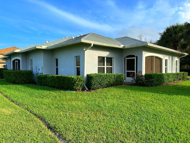 view of side of home with a lawn