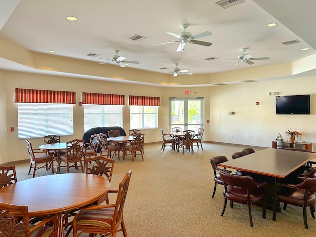 dining room with light carpet and french doors