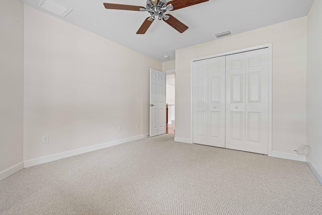 unfurnished bedroom featuring ceiling fan, a closet, and light colored carpet