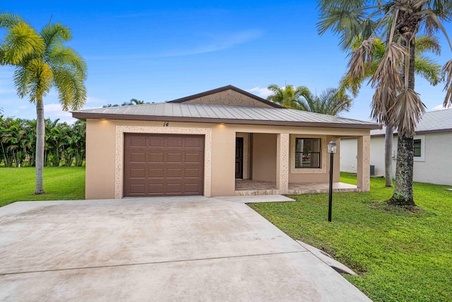 view of front of property with a garage and a front yard