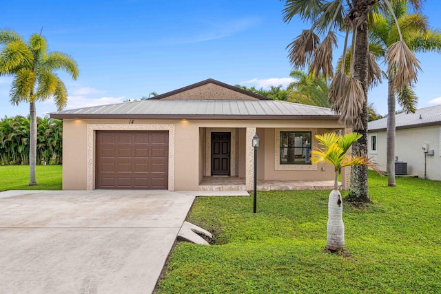 single story home featuring covered porch, a garage, a front yard, and central AC