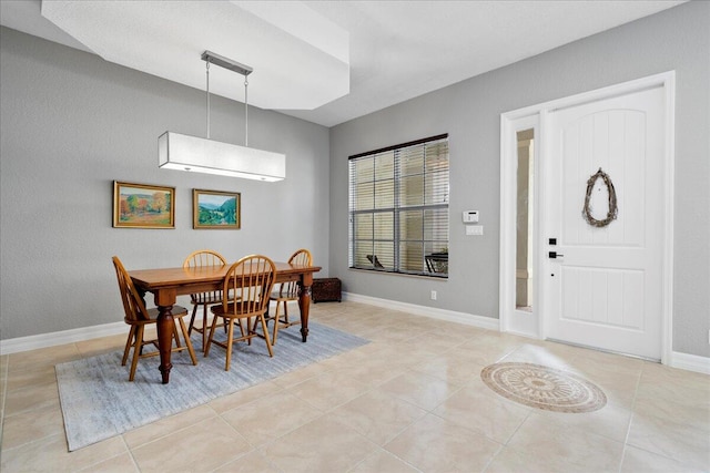 dining space featuring light tile patterned flooring