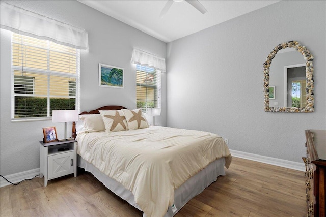 bedroom with ceiling fan and light wood-type flooring