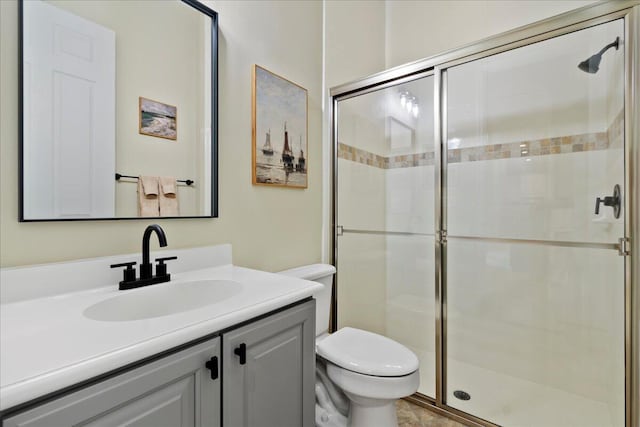 bathroom with vanity, toilet, and an enclosed shower