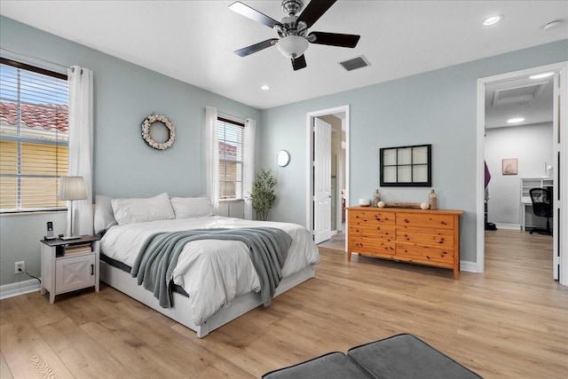 bedroom with ceiling fan and light hardwood / wood-style flooring