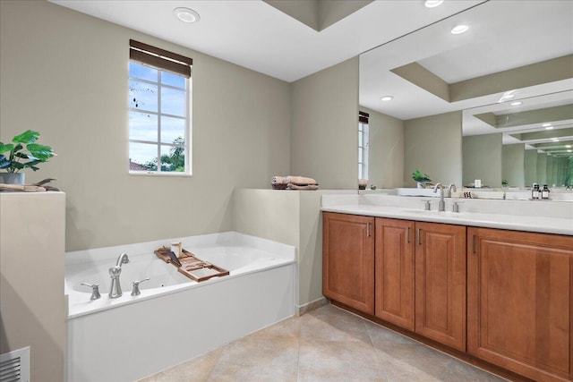 bathroom with a washtub and vanity