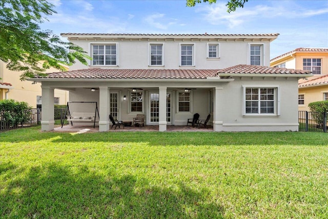 back of house featuring a patio and a lawn