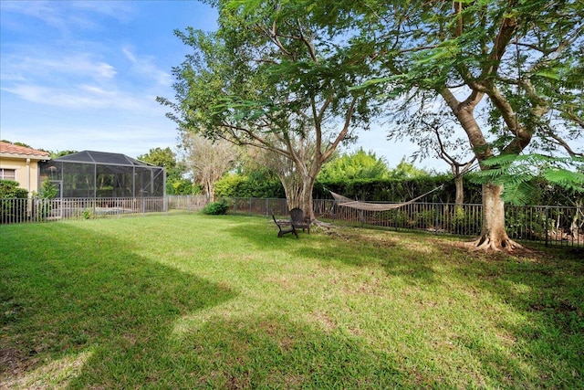 view of yard featuring glass enclosure