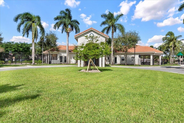 mediterranean / spanish house featuring a front yard