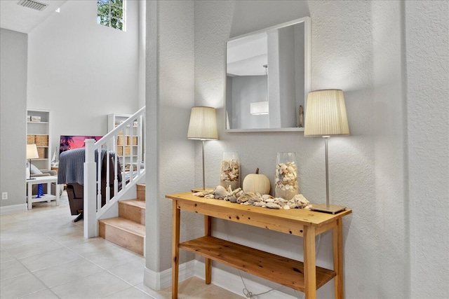 stairway featuring tile patterned flooring and a textured ceiling