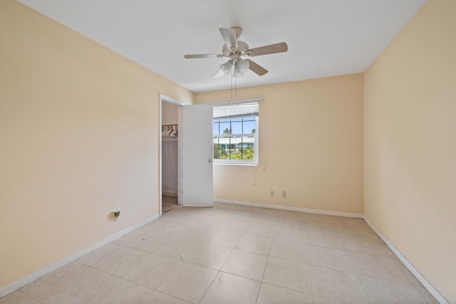 tiled empty room with ceiling fan