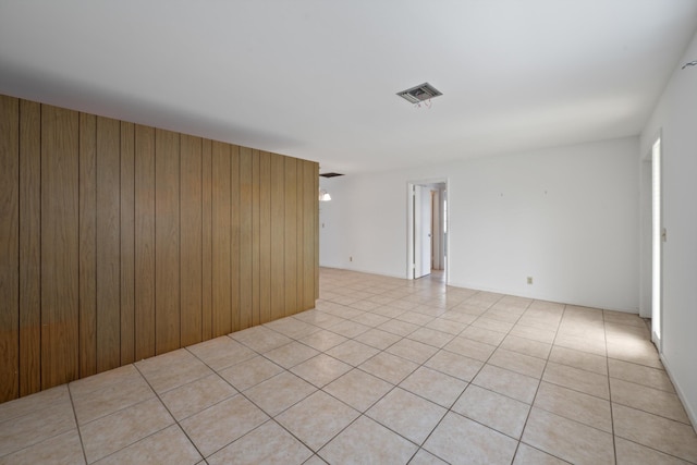 tiled empty room with wood walls