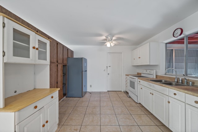 kitchen with white cabinets, white range with electric cooktop, and stainless steel refrigerator