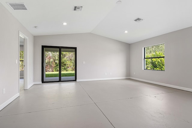 unfurnished room featuring a wealth of natural light and vaulted ceiling