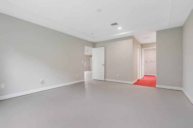 unfurnished room featuring concrete floors