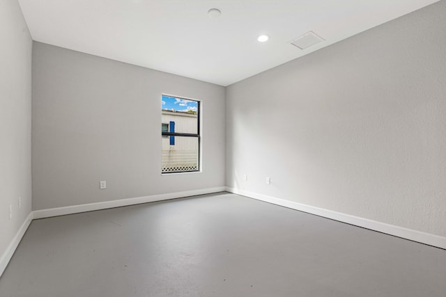 unfurnished room featuring concrete flooring