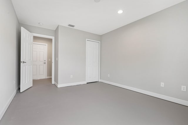 unfurnished bedroom featuring concrete flooring