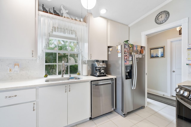 kitchen featuring white cabinetry, appliances with stainless steel finishes, ornamental molding, and sink