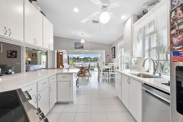 7770 SE Spicewood Cir, Hobe Sound, FL 33455 - kitchen with a sink, stainless steel dishwasher, lofted ceiling, light countertops, and light tile patterned floors