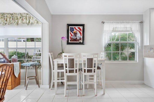 tiled dining space featuring ornamental molding