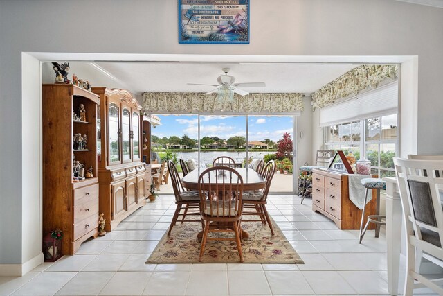 7770 SE Spicewood Cir, Hobe Sound, FL 33455 - dining area featuring a ceiling fan, light tile patterned floors, and a water view