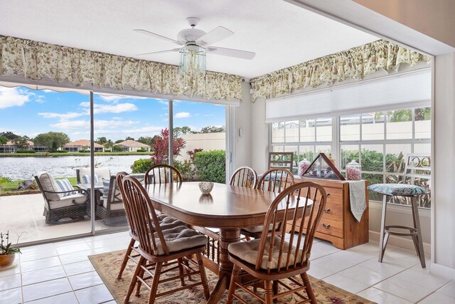 7770 SE Spicewood Cir, Hobe Sound, FL 33455 - dining area featuring a ceiling fan, light tile patterned floors, and a water view