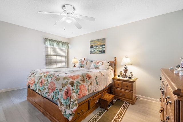 bedroom with ceiling fan and light hardwood / wood-style flooring