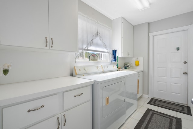 washroom with washing machine and dryer, cabinets, sink, and light tile patterned floors