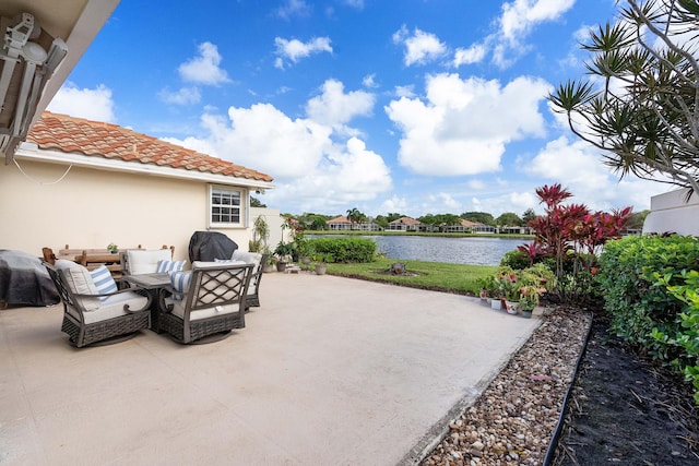 view of patio featuring a water view and area for grilling