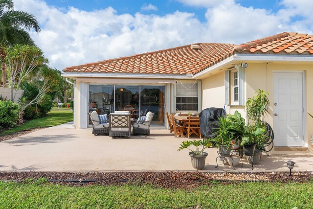 7770 SE Spicewood Cir, Hobe Sound, FL 33455 - back of house with a tile roof, a patio area, and stucco siding