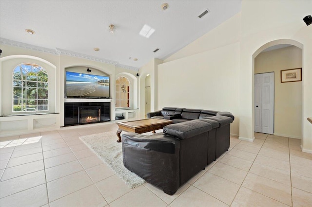 living room featuring light tile patterned flooring and vaulted ceiling