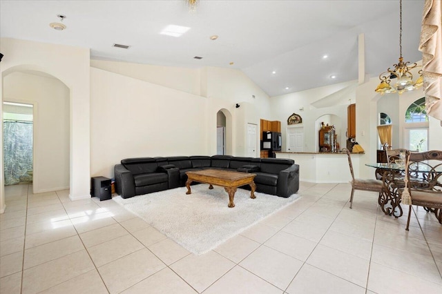 living room featuring high vaulted ceiling and light tile patterned flooring