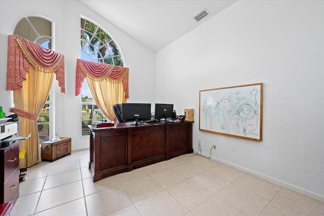 tiled home office featuring a healthy amount of sunlight and high vaulted ceiling